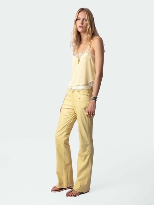 Light yellow silk camisole with thin straps and lace trim. -