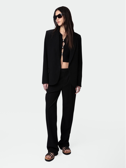 Black crepe tailored trousers with pockets and hems. -