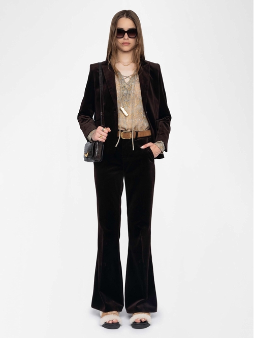 Velvet trousers with flared legs and mid-rise waist. -