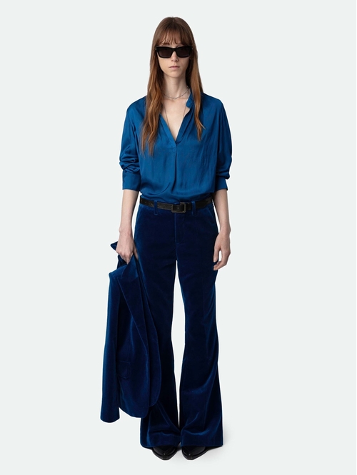 Velvet trousers with flared legs and mid-rise waist. -