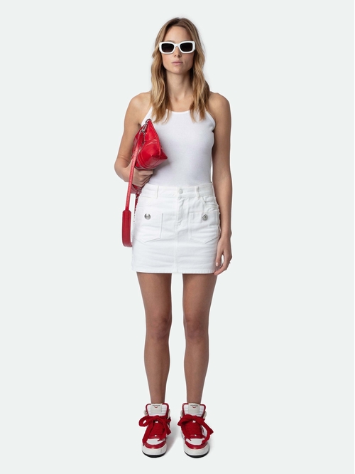 White denim mini skirt with pockets, raw edges and buttons.