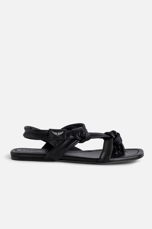 Women's black flat leather sandals with wing motifs.