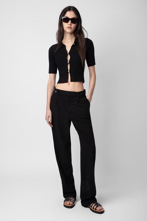 Black crepe tailored trousers with pockets and hems. -